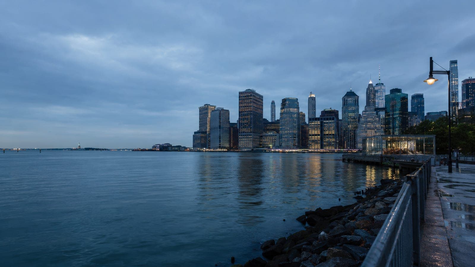 Waterfront city skyline at blue hour.